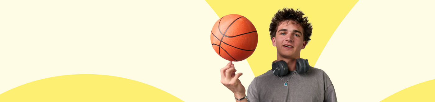 Person holding a basketball against a yellow and white background