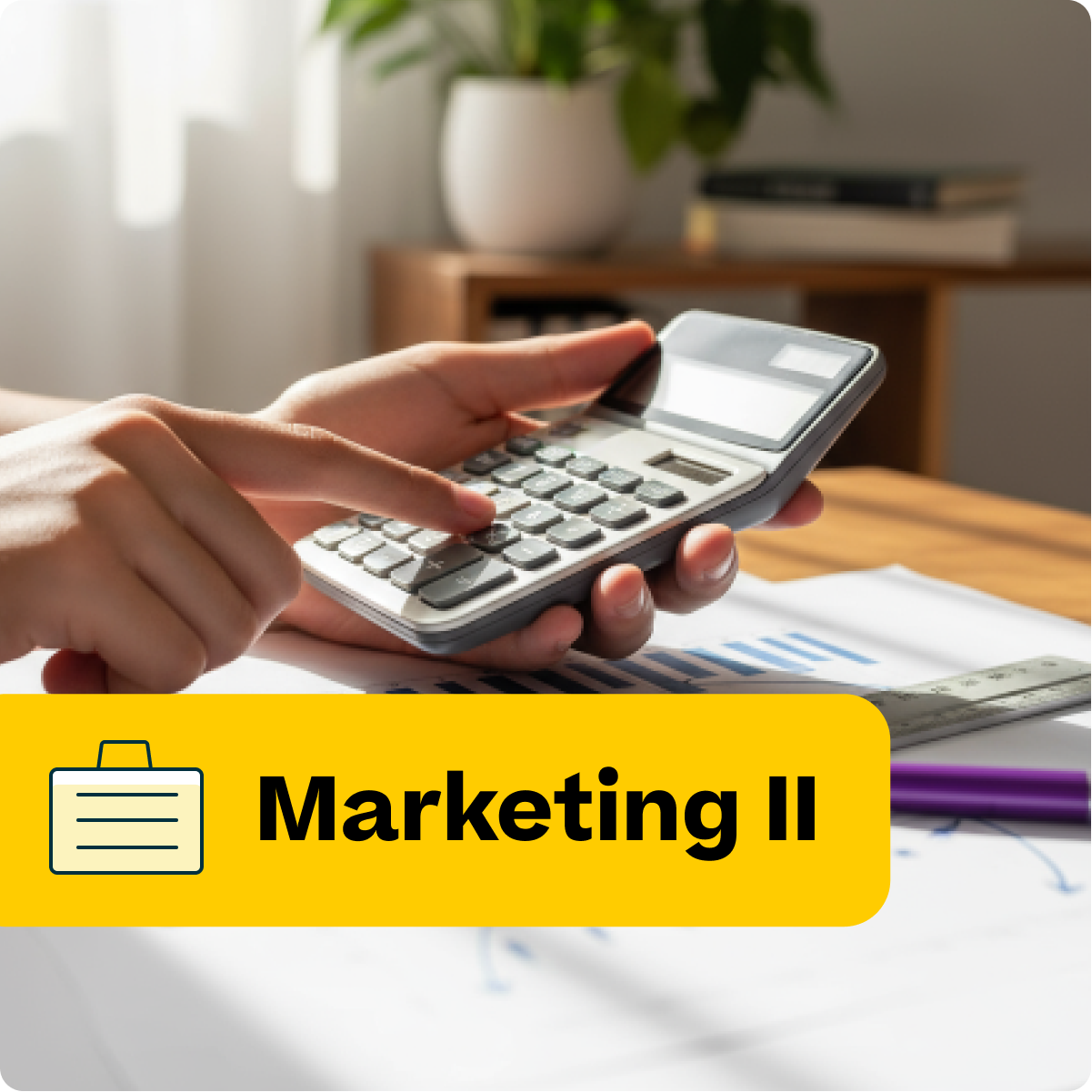 Person using a calculator with educational materials and a plant in the background, labeled 'Marketing II'.
