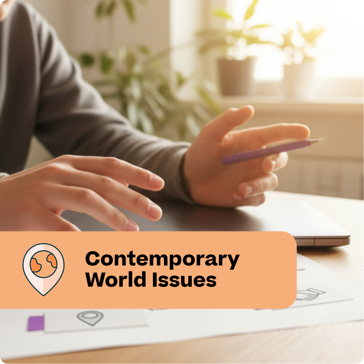 Person holding a pen with 'Contemporary World Issues' text overlay on a desk.