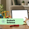 Person interacting with a tablet on a desk with educational items, featuring 'Embark Science' branding.