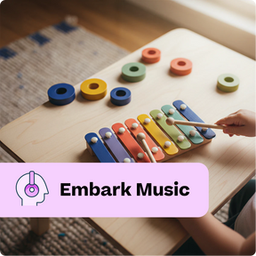 Child playing with a colorful wooden xylophone on a table, with 'Embark Music' branding.