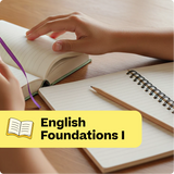 Open book with a hand on a wooden surface, next to a notebook and pencil, with 'English Foundations I' text overlay.