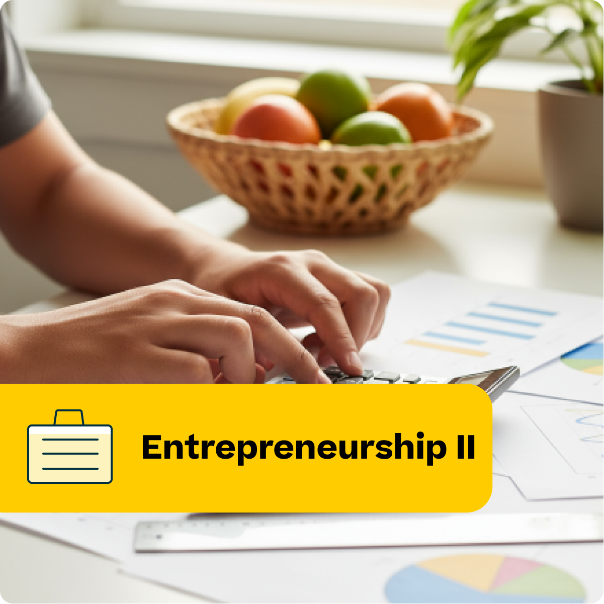 Person typing on a laptop with a bowl of fruit and documents in the background, featuring the text 'Entrepreneurship II'.