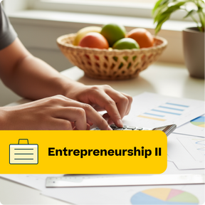 Person typing on a laptop with a bowl of fruit and documents in the background, featuring the text 'Entrepreneurship II'.