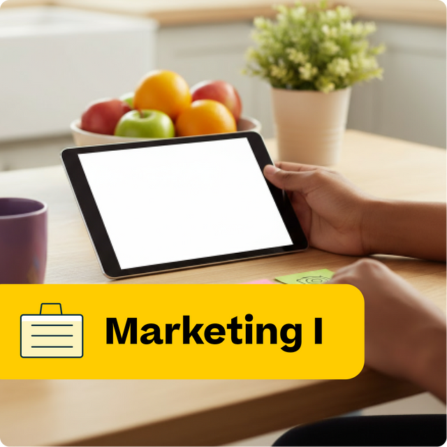 Person using a tablet on a table with fruits and a plant, labeled 'Marketing I'.