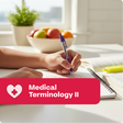 Person studying medical terminology with a bowl of fruits and a plant in the background