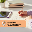 Person studying modern U.S. history with books and a tablet on a desk.